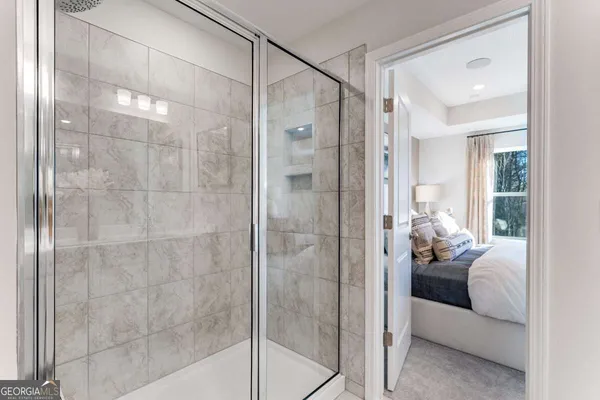 a bathroom with a glass shower door
