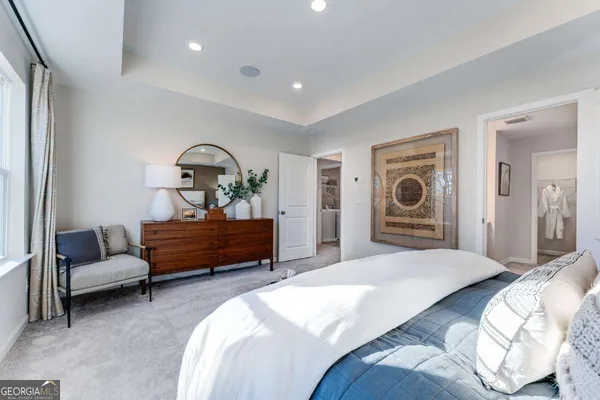 a bedroom with a bed and a chair