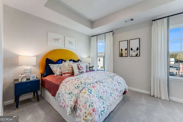 a bedroom with a bed and a painting on the wall