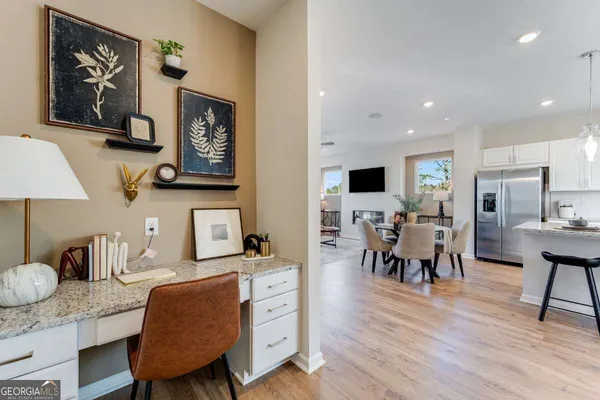 a dining room with furniture and wooden floor