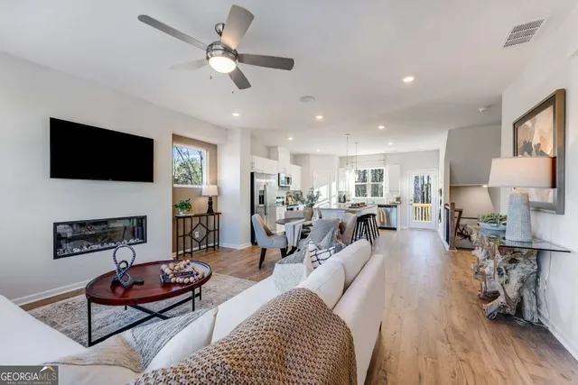 a living room with furniture a fireplace and a flat screen tv