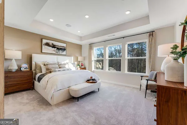 a spacious bedroom with a bed and large windows