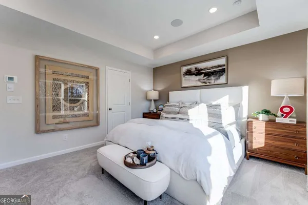 a bedroom with a bed and a couch