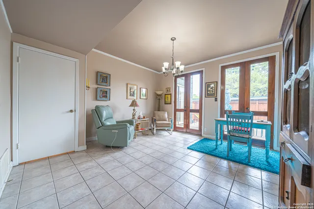 a living room with furniture and a chandelier