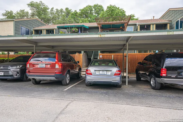 a view of backyard of house with green space