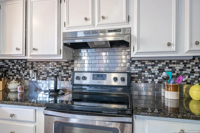 a kitchen with a stove and cabinets