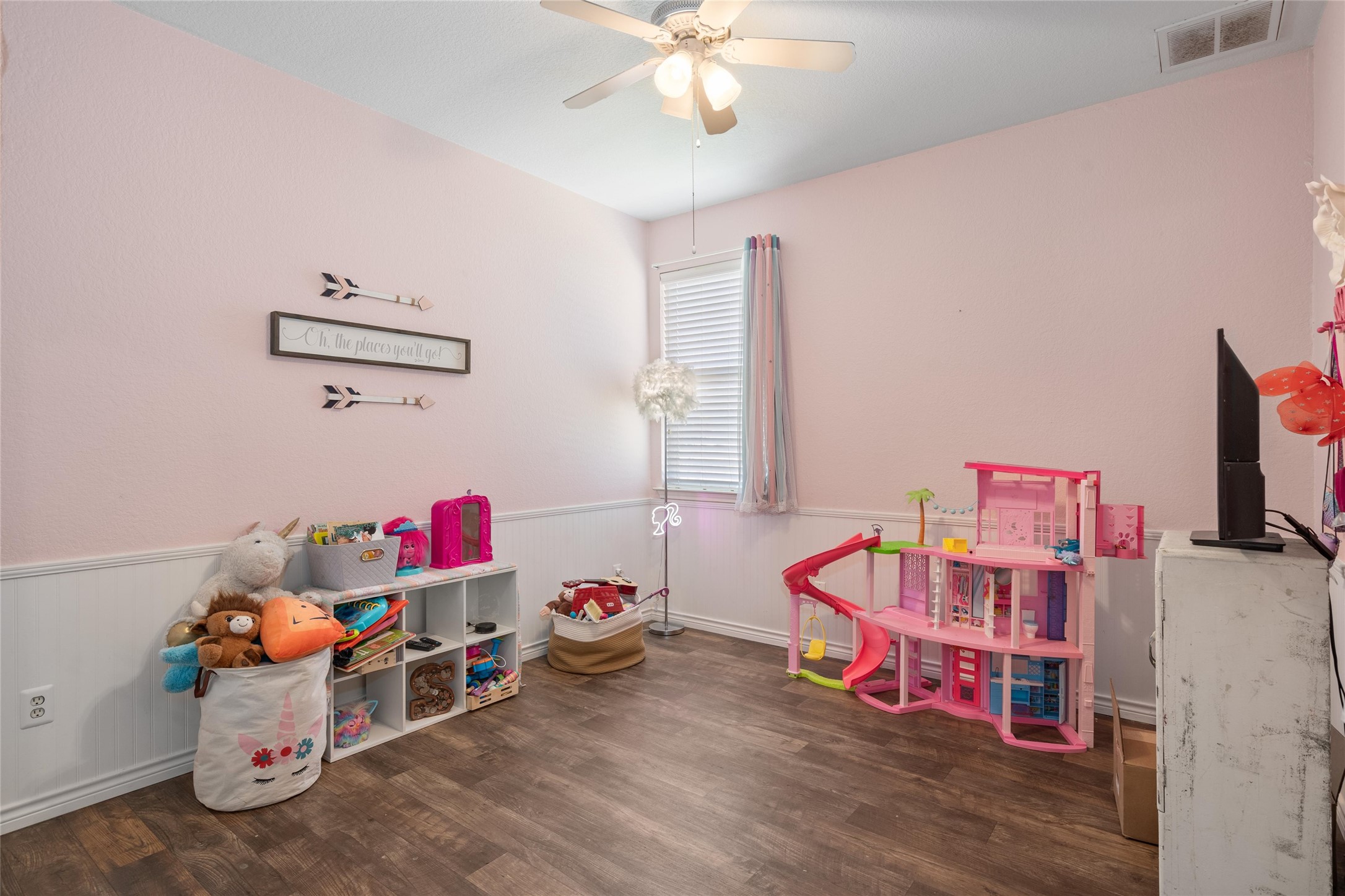 149 Dropper Kyle, TX 78640 - Photo 30 of 33 Smooth wood-style flooring and classic wainscoting bring timeless character to this versatile bedroom.