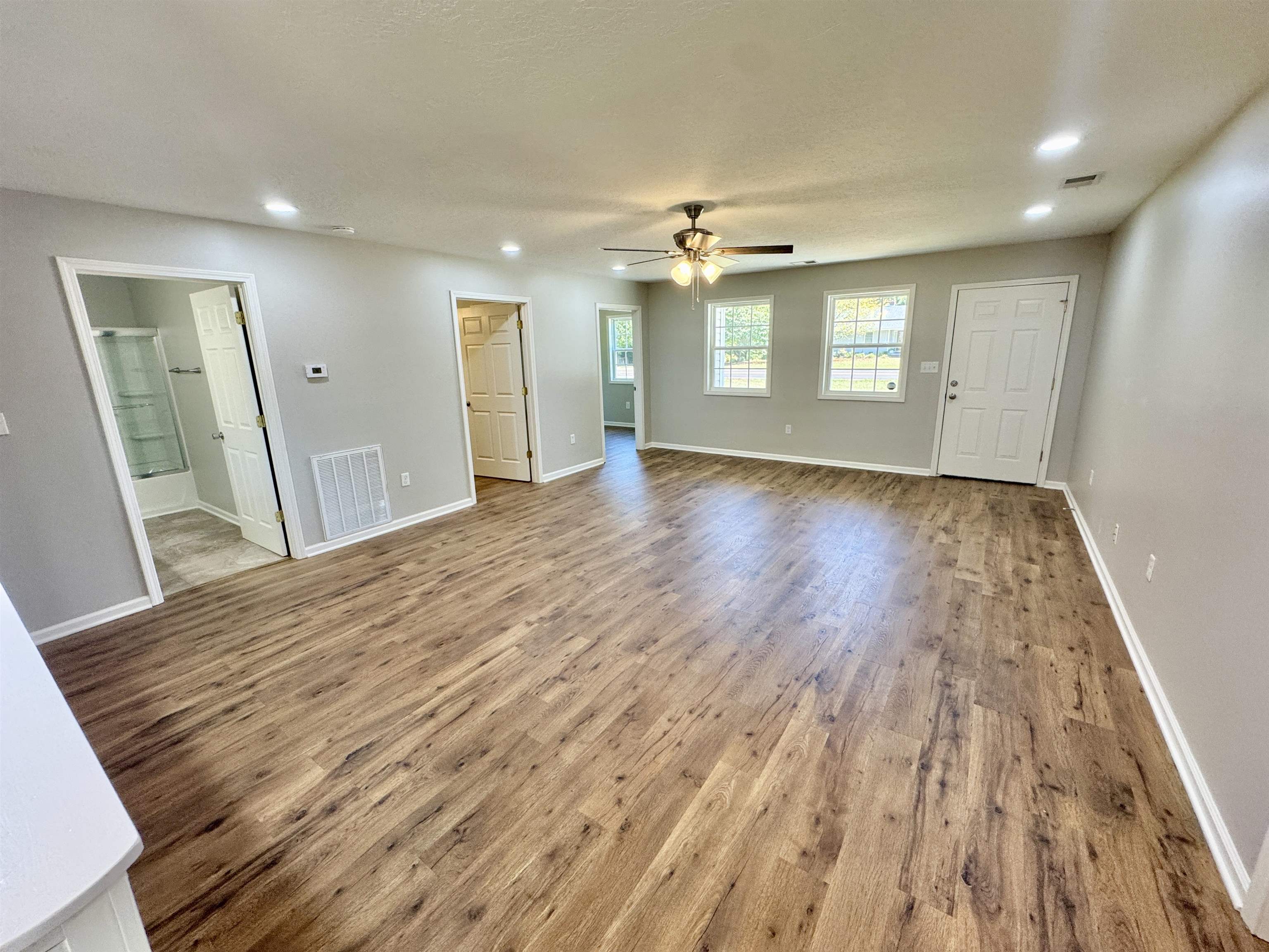4638 Asbury Glimp Road Ripley, TN 38063 - Photo 10 of 16 wooden floor in an empty room with a window