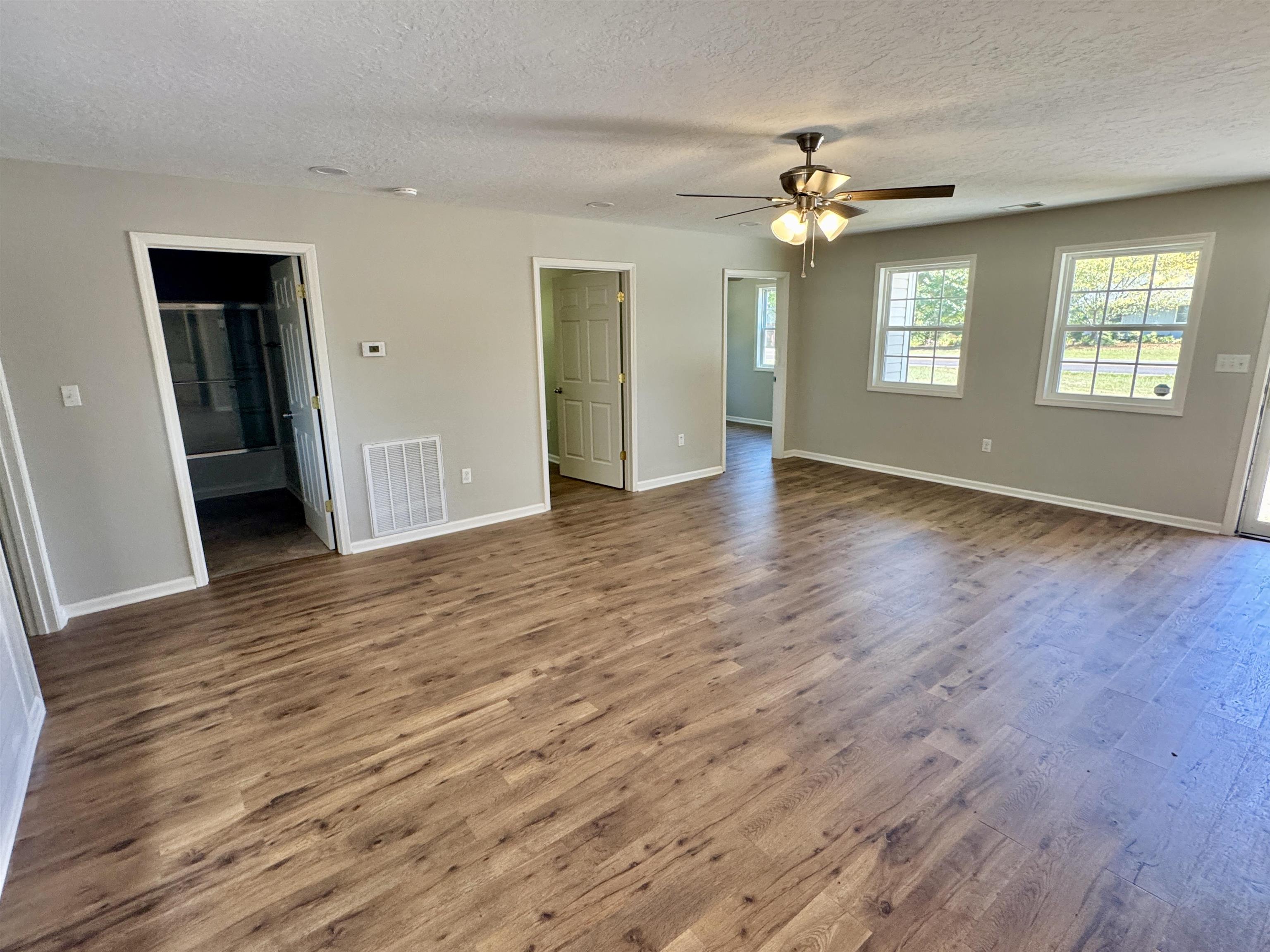 4638 Asbury Glimp Road Ripley, TN 38063 - Photo 11 of 16 a view of an empty room with a window and wooden floor
