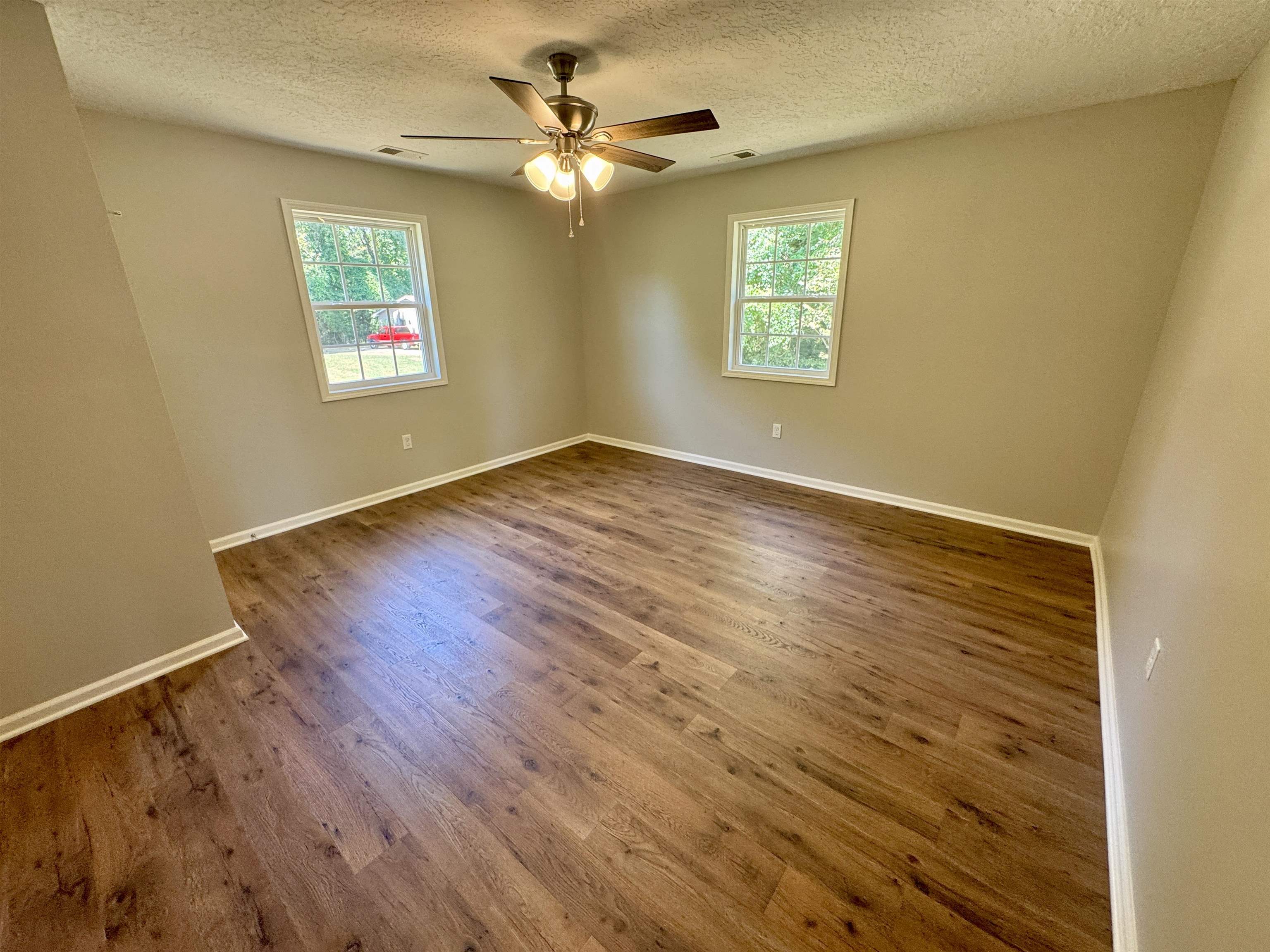 4638 Asbury Glimp Road Ripley, TN 38063 - Photo 12 of 16 a view of an empty room with a window and wooden floor