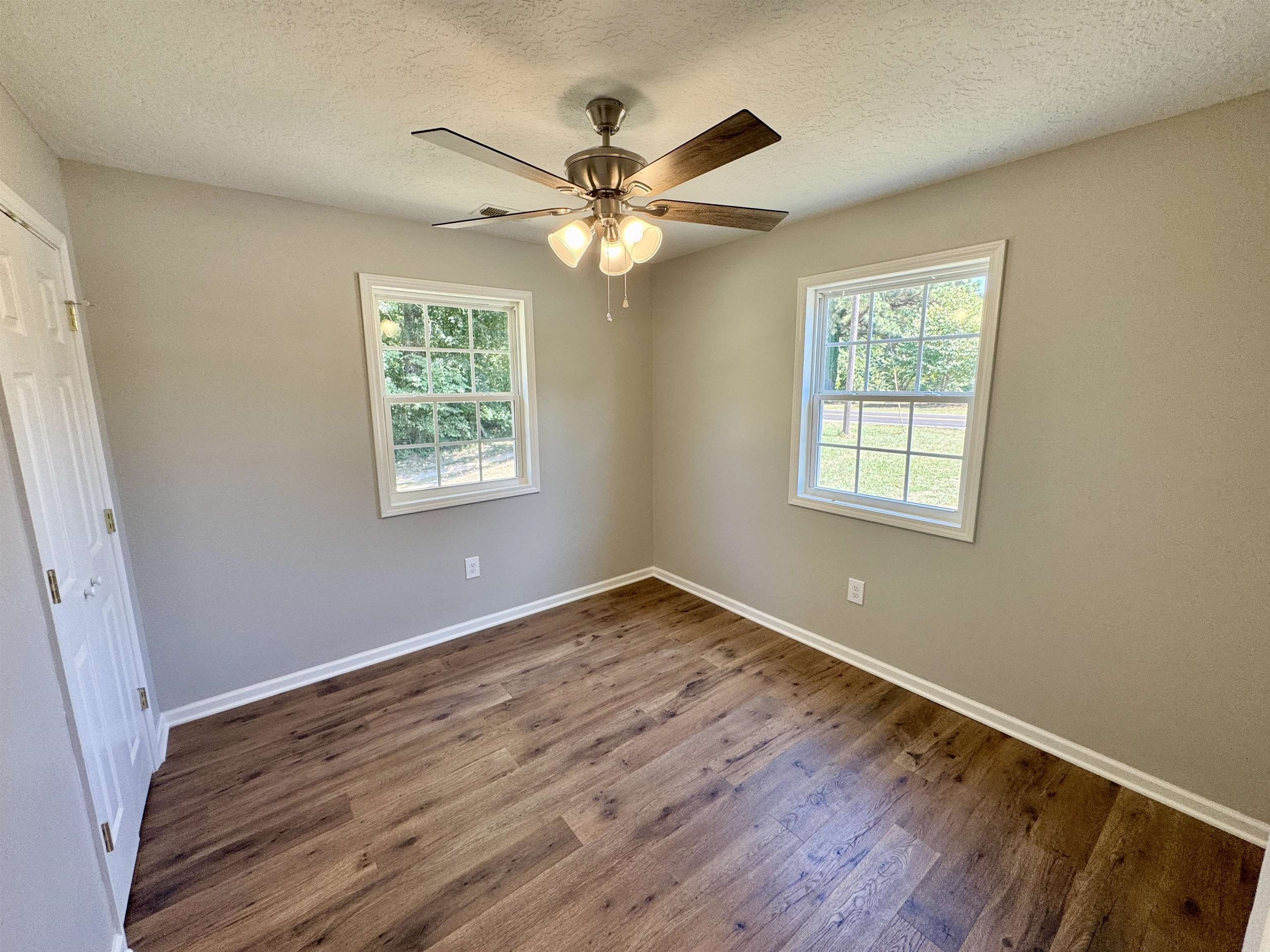 4638 Asbury Glimp Road Ripley, TN 38063 - Photo 15 of 16 a view of an empty room with wooden floor and a window