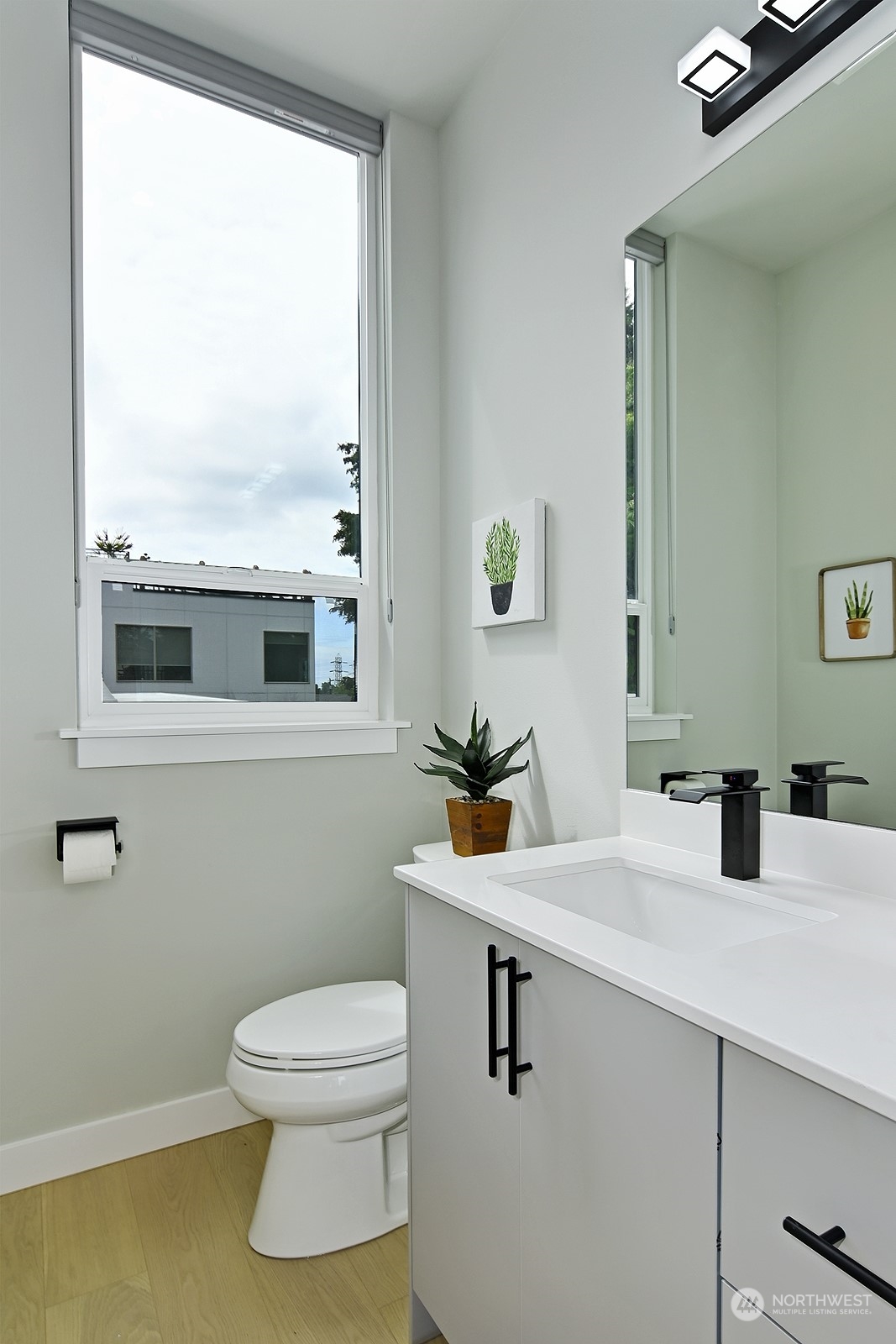2707 South Ferdinand Street Seattle, WA 98108 - Photo 22 of 38 a bathroom with a sink a toilet and a mirror