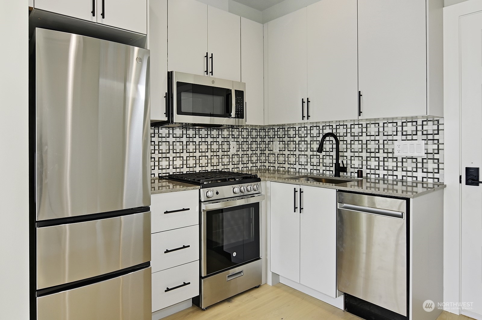 2707 South Ferdinand Street Seattle, WA 98108 - Photo 30 of 38 a kitchen with stainless steel appliances a refrigerator sink and microwave