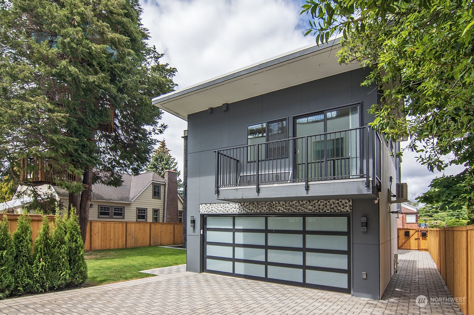 2707 South Ferdinand Street Seattle, WA 98108 - Photo 5 of 38 a front view of a house with a garden and trees