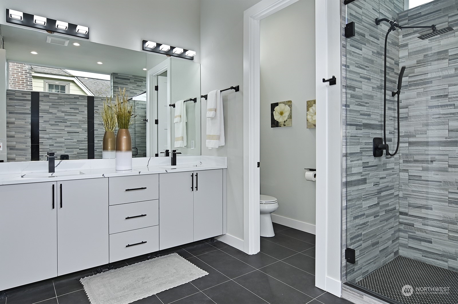 2707 South Ferdinand Street Seattle, WA 98108 - Photo 8 of 38 a bathroom with a double vanity sink a mirror and a shower
