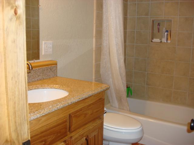 44433 Dee Knoch Road Fall River Mills, CA 96028 - Photo 6 of 9 a bathroom with a granite countertop sink toilet and shower