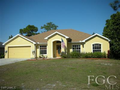 9017 Morris Road Fort Myers, FL 33967 - Photo 1 of 10 a front view of a house with a yard