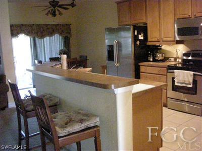 9017 Morris Road Fort Myers, FL 33967 - Photo 3 of 10 a kitchen with a table and chairs