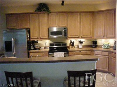 9017 Morris Road Fort Myers, FL 33967 - Photo 4 of 10 a kitchen with a stove a sink and cabinets