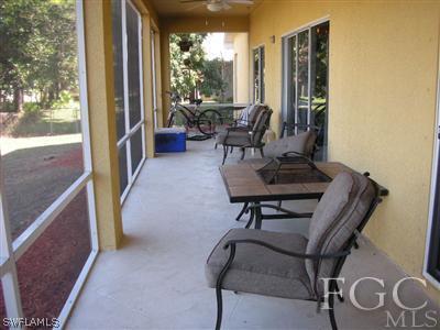 9017 Morris Road Fort Myers, FL 33967 - Photo 9 of 10 a living room with furniture and a floor to ceiling window