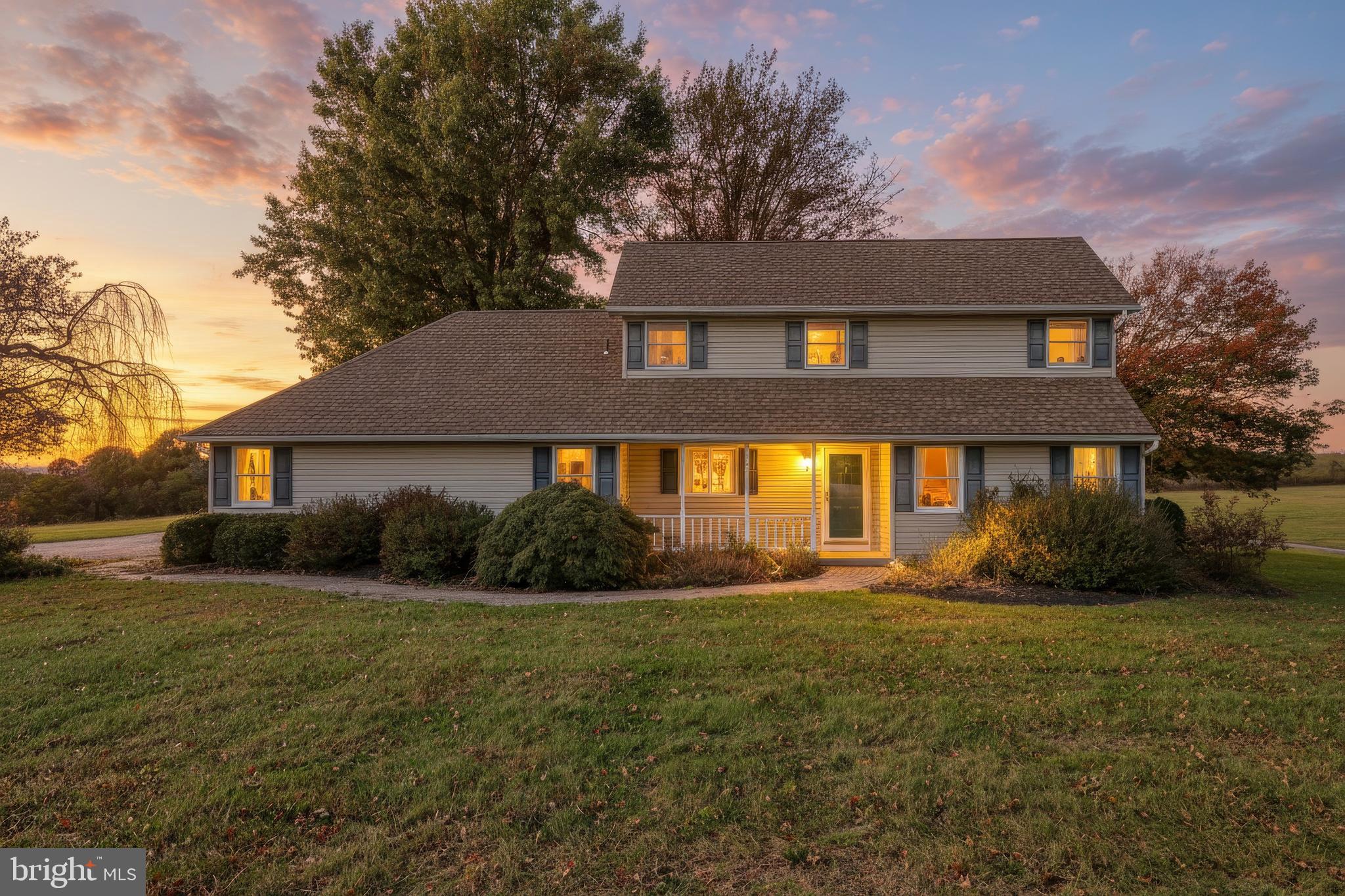a front view of house with yard and green space