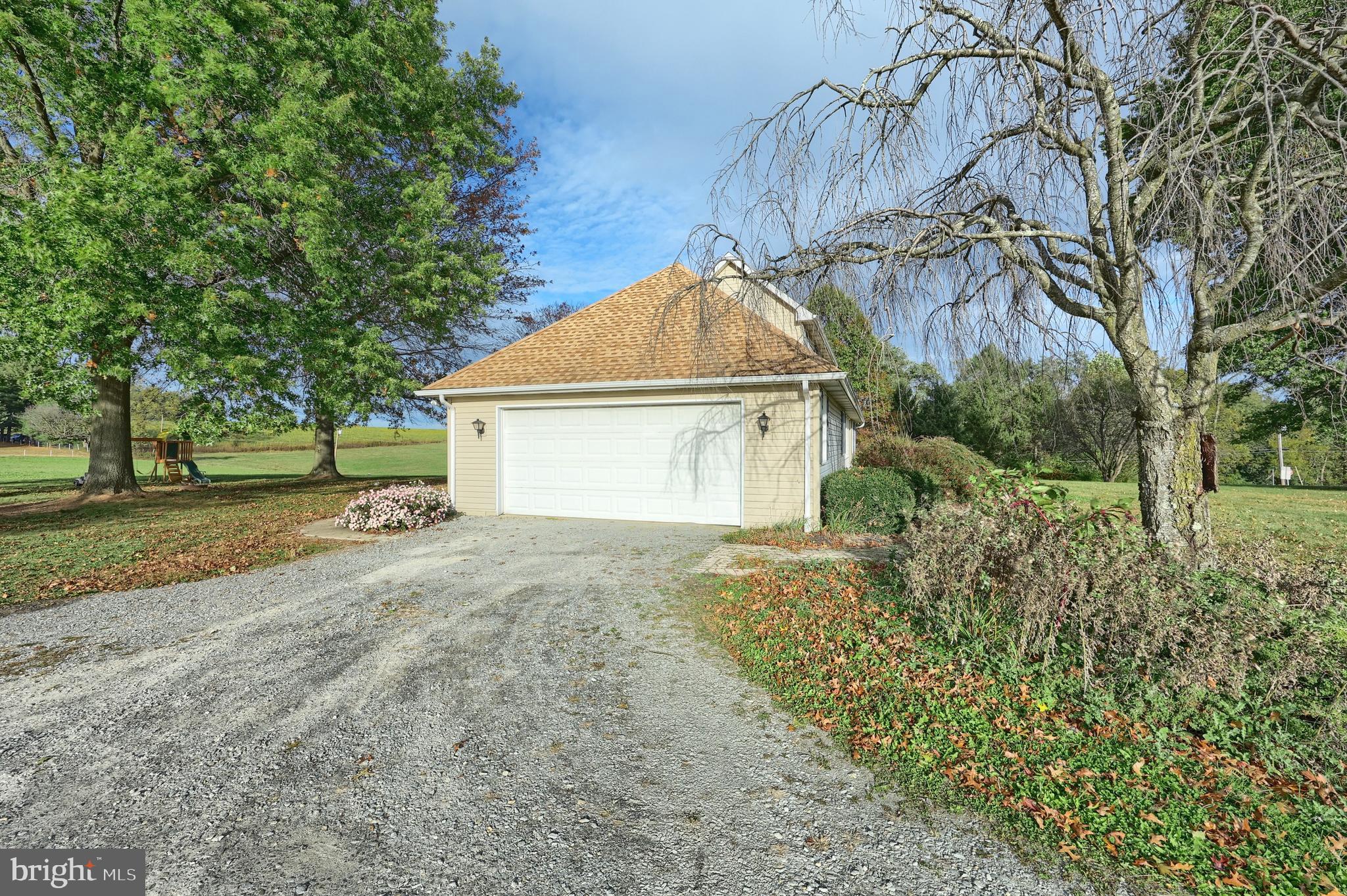 4877 Battlehill Road Brogue, PA 17309 - Photo 16 of 49 a view of a house with a yard and garage