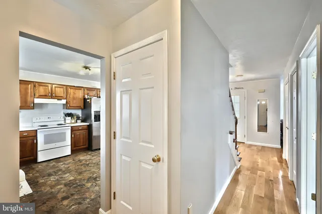 a bathroom with a granite countertop sink a large mirror and a refrigerator