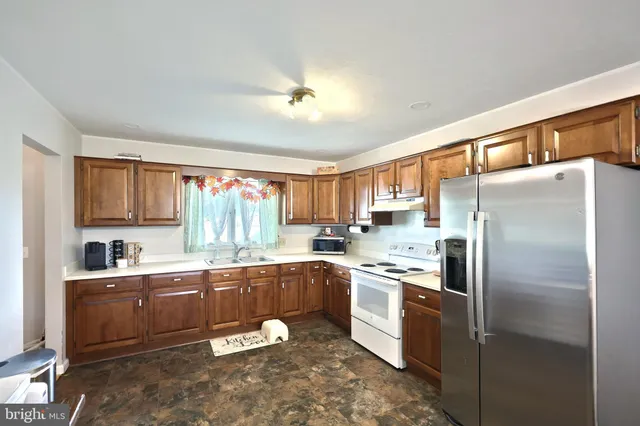 a kitchen with a sink stainless steel appliances and cabinets