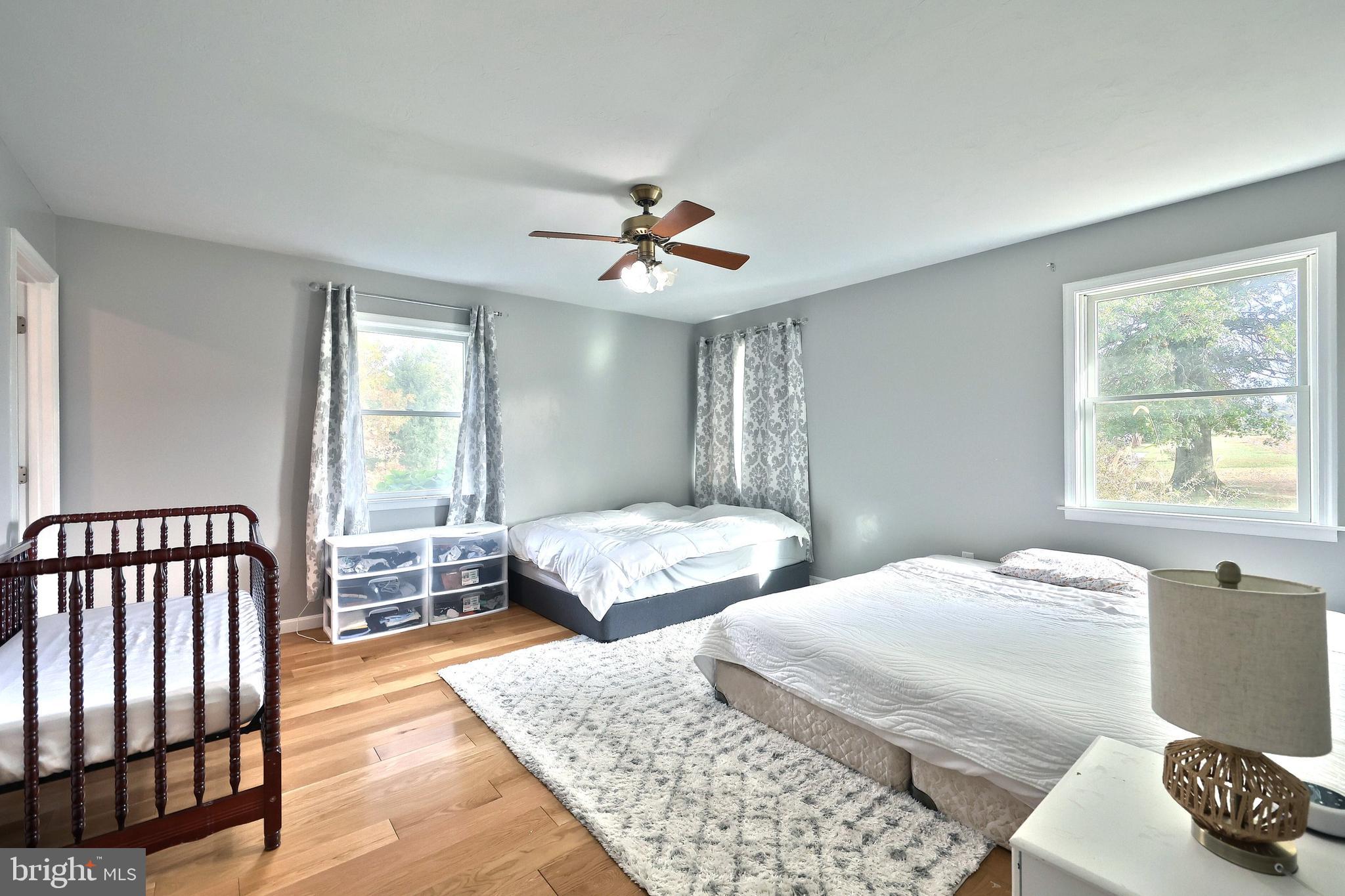 4877 Battlehill Road Brogue, PA 17309 - Photo 25 of 49 a bedroom with two beds and a chandelier