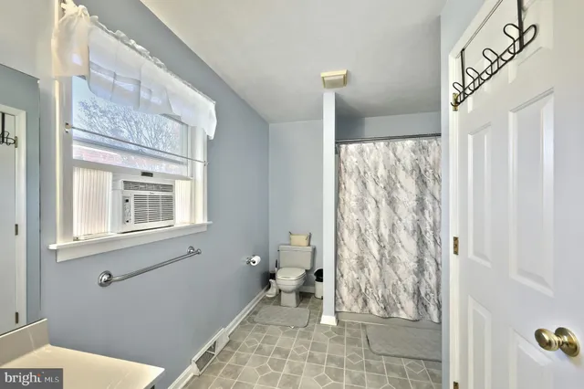 a view of a room with wooden floor and white walls