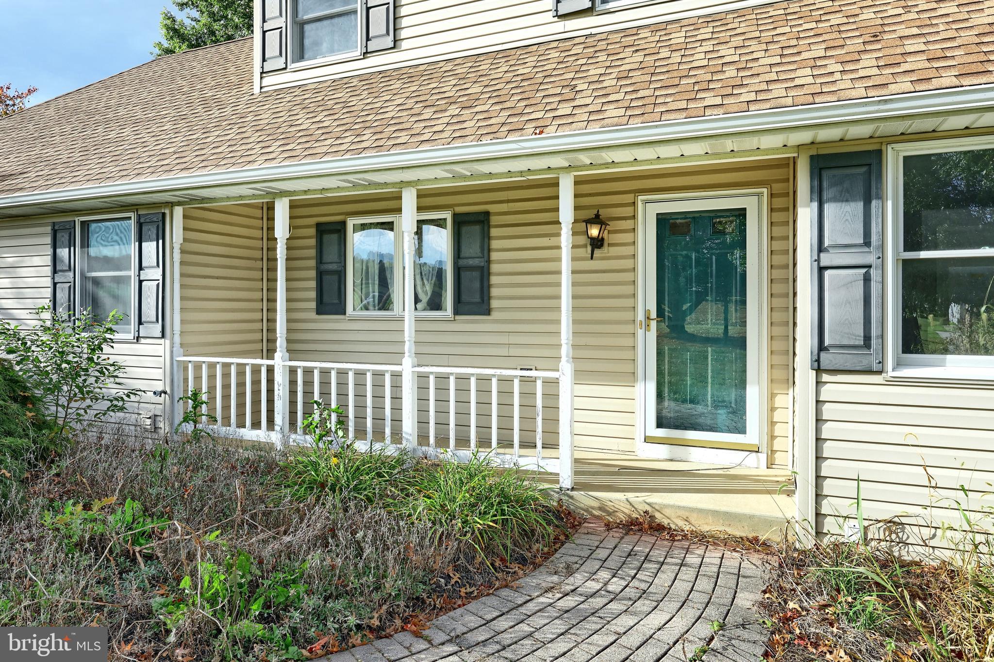 4877 Battlehill Road Brogue, PA 17309 - Photo 8 of 49 a view of a house with a small deck and a garden
