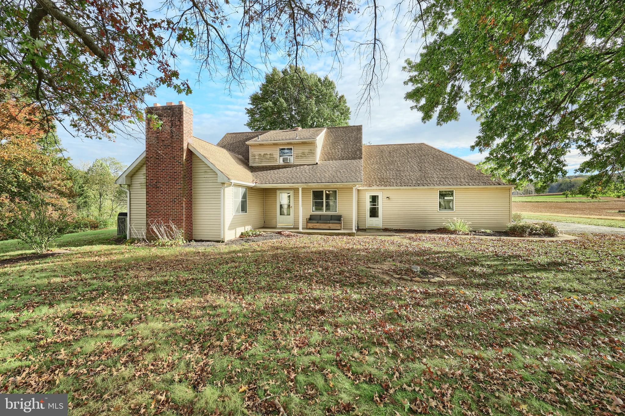 4877 Battlehill Road Brogue, PA 17309 - Photo 9 of 49 a front view of a house with a garden