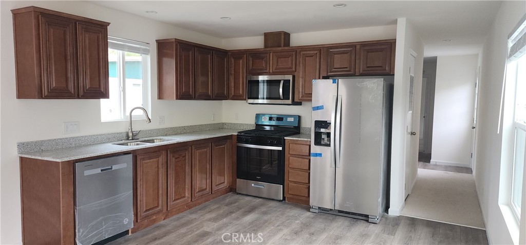 3390 Taylor Road, Unit 17 Loomis, CA 95650 - Photo 2 of 8 a kitchen with stainless steel appliances granite countertop a refrigerator stove and sink