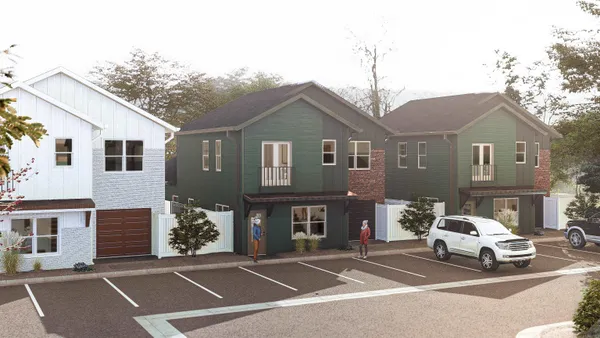 a view of a white house next to a road with large trees