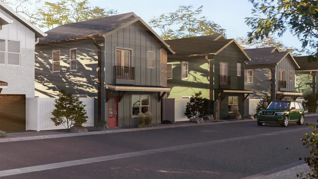 a front view of a house with a yard and mountain view