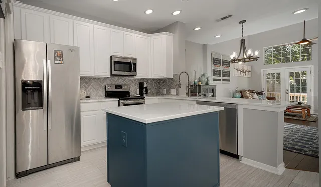 a kitchen with stainless steel appliances a sink stove and refrigerator