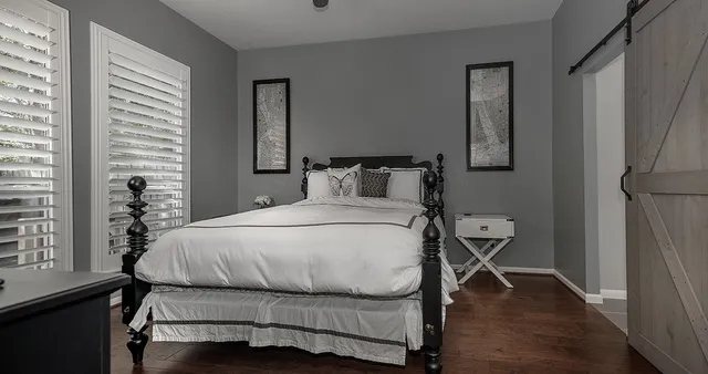 a bedroom with a bed and wooden floor
