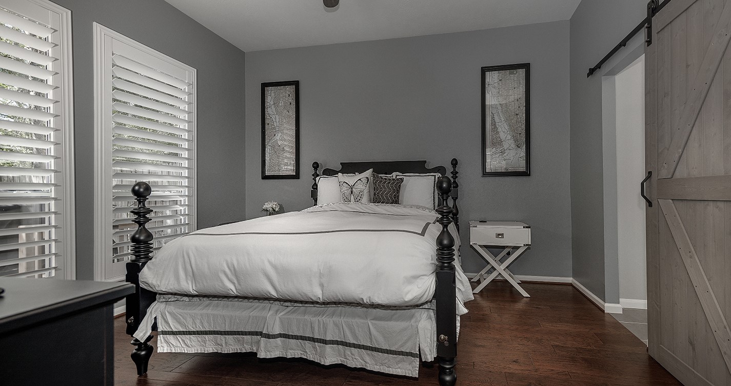 110 Wintergreen Trail The Woodlands, TX 77382 - Photo 15 of 32 a bedroom with a bed and wooden floor