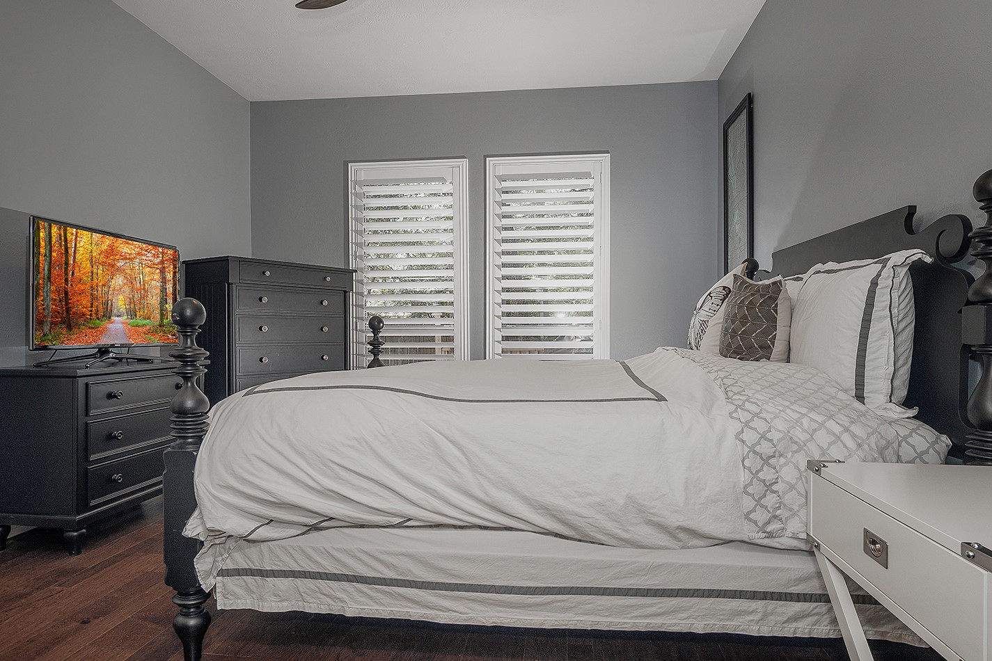 110 Wintergreen Trail The Woodlands, TX 77382 - Photo 16 of 32 a bedroom with a bed and a flat screen tv