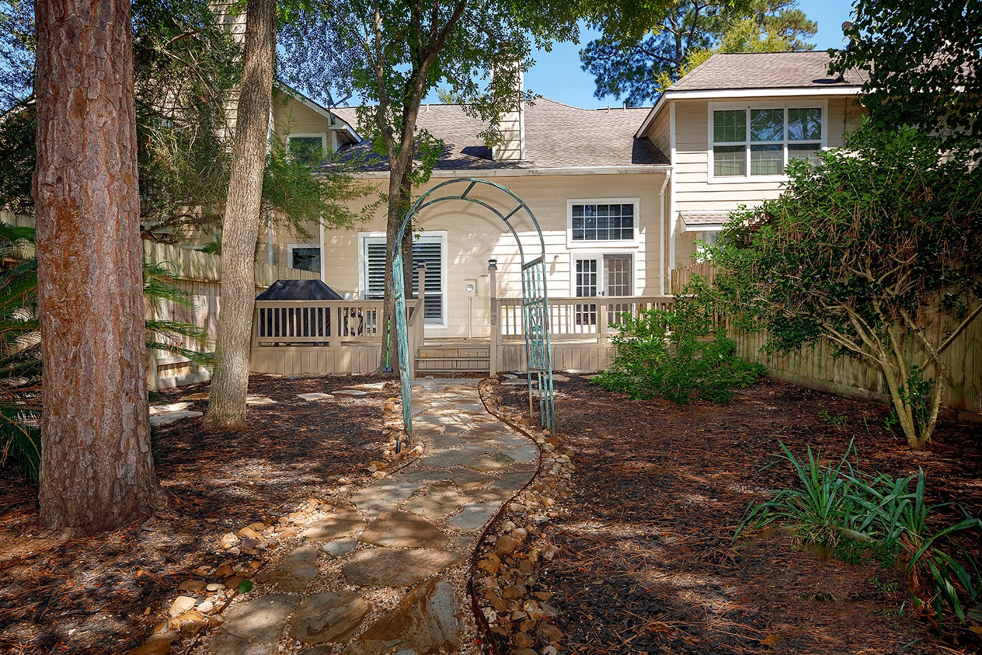 110 Wintergreen Trail The Woodlands, TX 77382 - Photo 30 of 32 a view of a white house with a yard and large tree