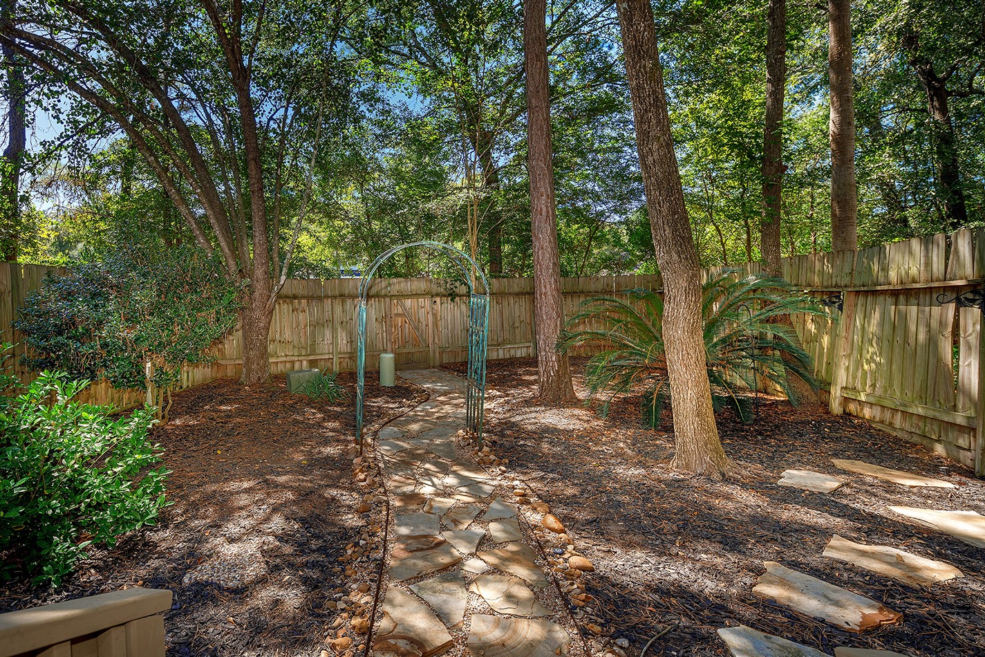 110 Wintergreen Trail The Woodlands, TX 77382 - Photo 31 of 32 a backyard of a house with lots of green space