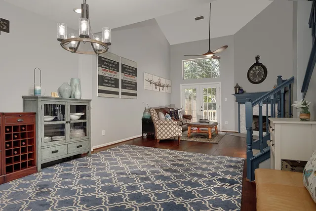 a living room with furniture and a chandelier