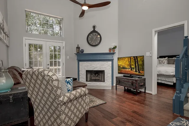 a living room with furniture a fireplace and a flat screen tv