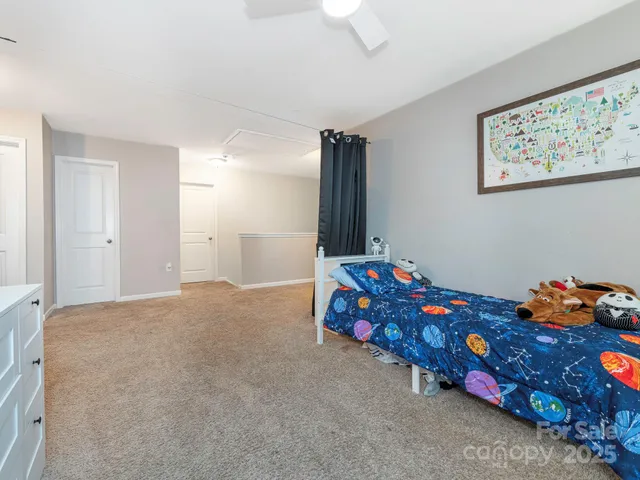 a bedroom with a bed and a dresser in it