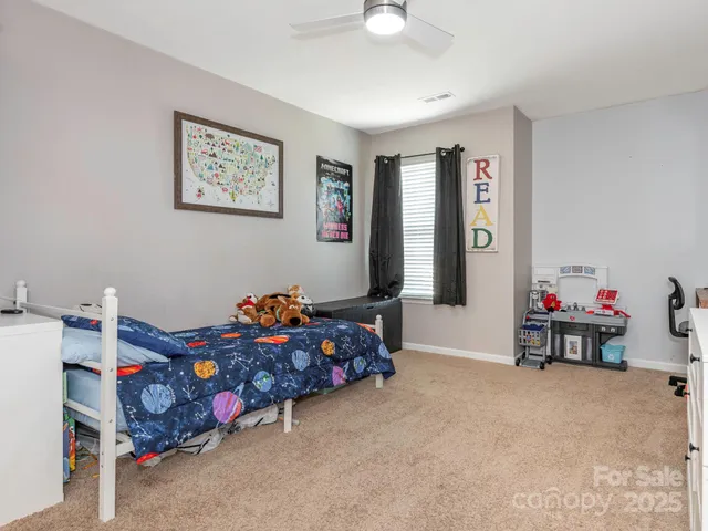 a bedroom with bed and a chandelier
