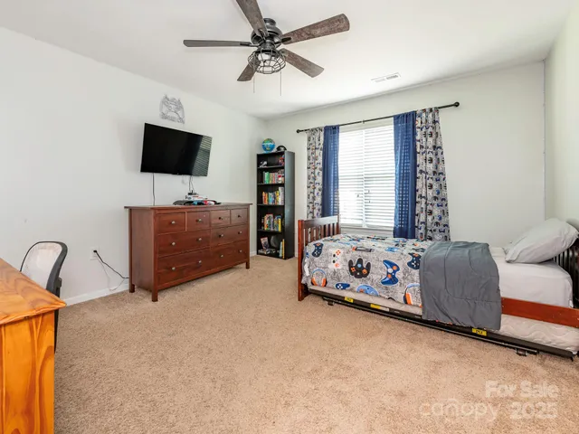 a bedroom with furniture and flat screen tv