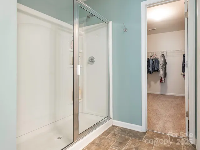 a bathroom with a glass shower door