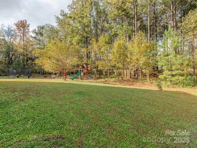 a view of outdoor space with garden and trees