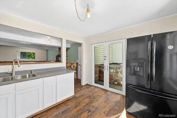 a kitchen with a refrigerator and a sink
