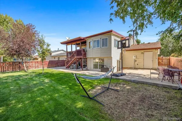 a view of a house with backyard porch and sitting area